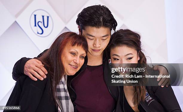 Alex Shibutan of the United States hugs is sister and parter Maia and their coach Marina Zueva while waiting for the results in the Ice Dance Free...