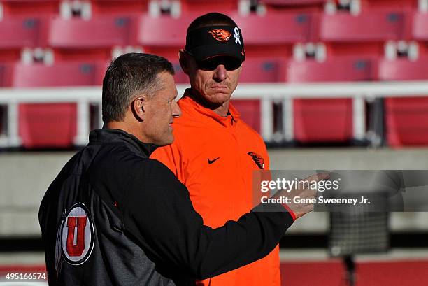 Head coach Kyle Whittingham of the Utah Utes and head coach Gary Andersen of the Oregon State Beavers talk before the game between the Utes and the...