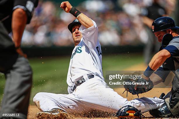Willie Bloomquist of the Seattle Mariners is tagged out by catcher Bryan Holaday of the Detroit Tigers attempt to score from third base in the third...