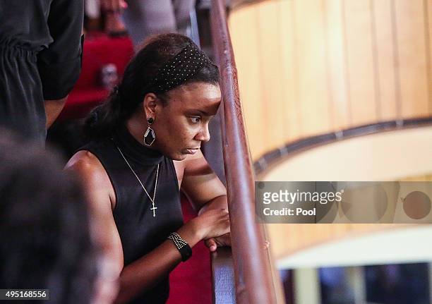 In this handout photo provided by the Palm Beach Post, A woman peers from the balcony during the funeral for Corey Jones at Payne Chapel AME Church...
