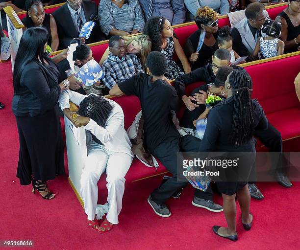 In this handout photo provided by the Palm Beach Post, Family members cry during the opening moments of the funeral for Corey Jones held at Payne...