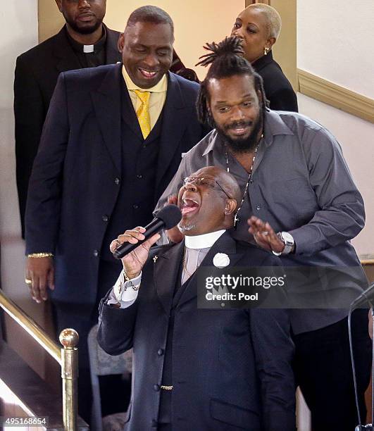 In this handout photo provided by the Palm Beach Post, A minister sings at the funeral for Corey Jones held at Payne Chapel AME Church October 31,...