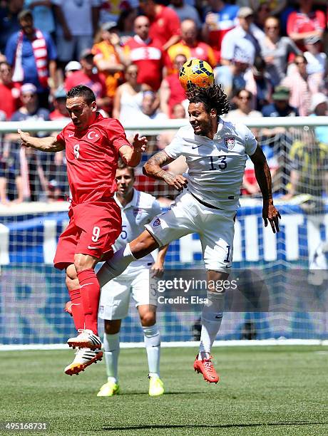 Jermaine Jones of the United States heads the ball as Mevlut Erdinc of Turkey defends during an international friendly match at Red Bull Arena on...