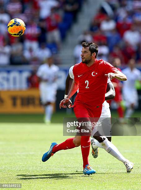 Hakan Kadir Balta of Turkey and Jozy Altidore of United States chase after the ball during an international friendly match at Red Bull Arena on June...