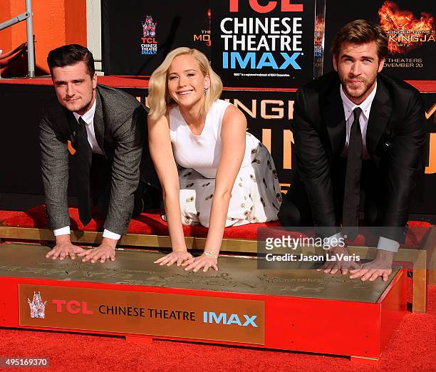 Josh Hutcherson, Jennifer Lawrence and Liam Hemsworth attend "The Hunger Games: Mockingjay - Part 2" hand and footprint ceremony at TCL Chinese...