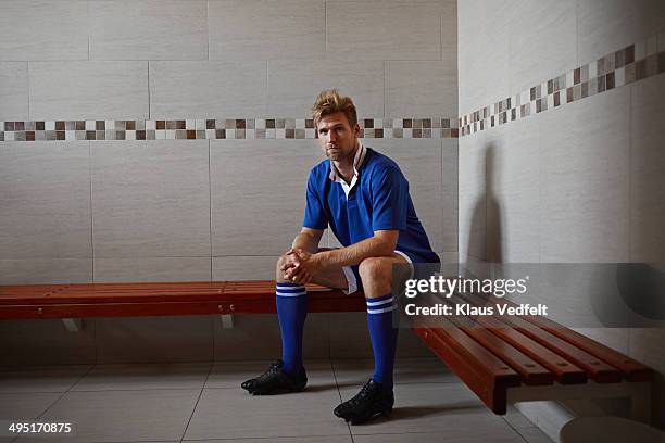 football player sitting alone in changing room - locker room stock pictures, royalty-free photos & images