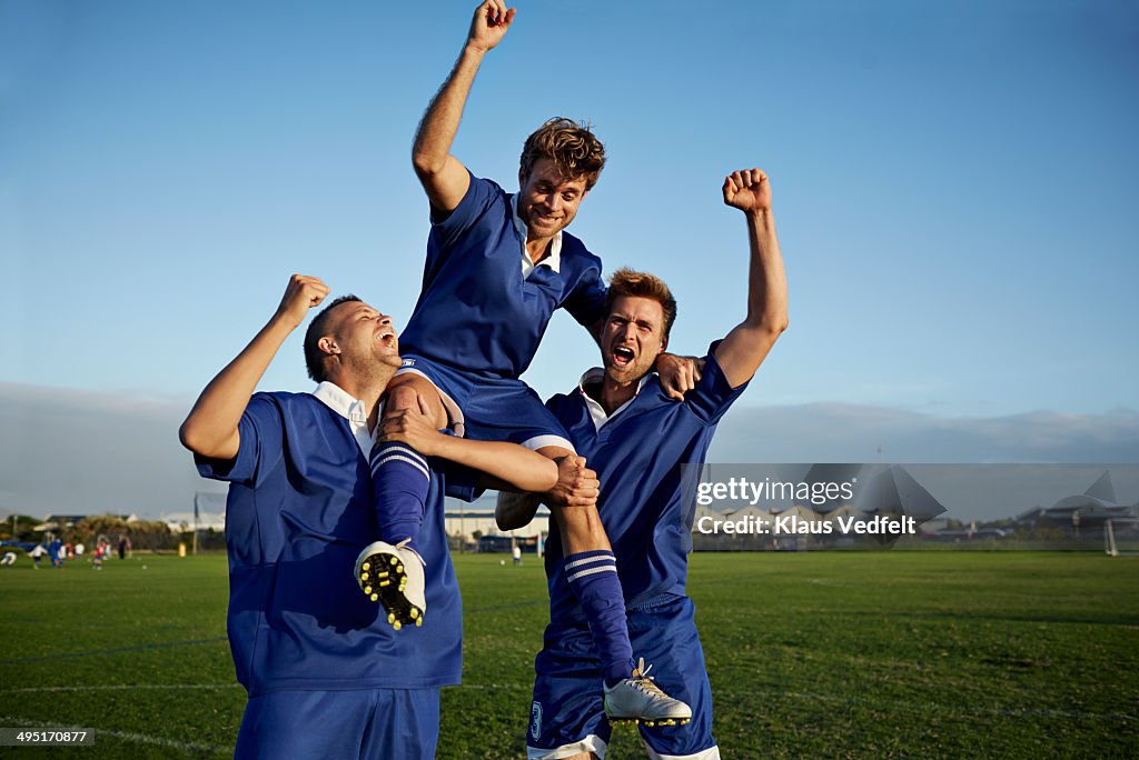 Football players cheering after goal