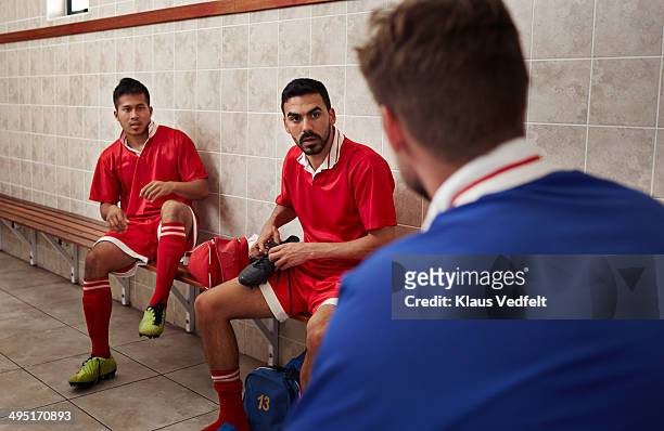football teammates talking in changing room - locker room bildbanksfoton och bilder
