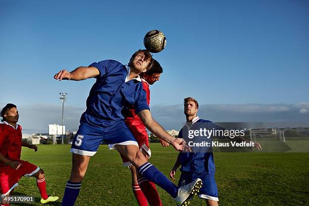 two soccer players battling to head the ball - heading the ball stock pictures, royalty-free photos & images