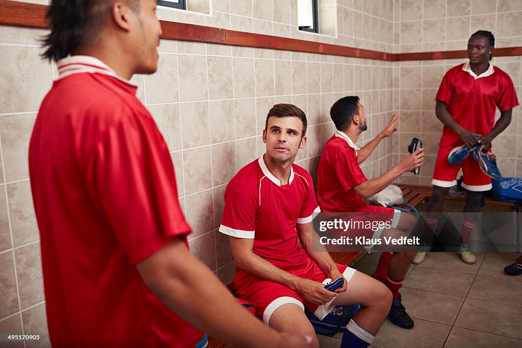 Football teammates talking in changing room
