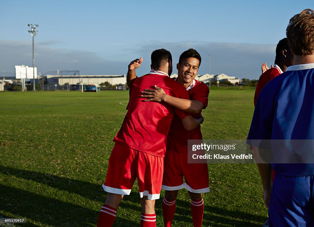 Teammates hugging after football game