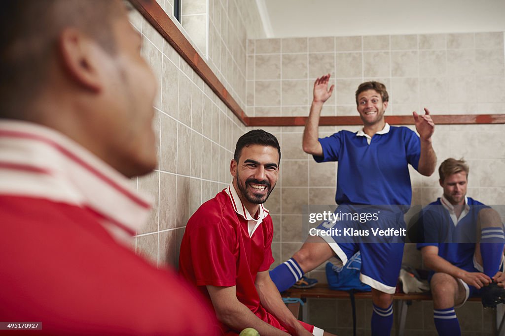 Football teammates laughing in changing room