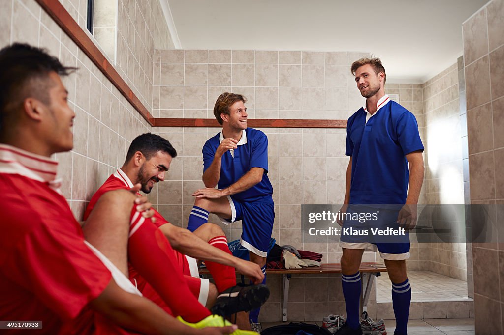 Football teammates laughing in changing room