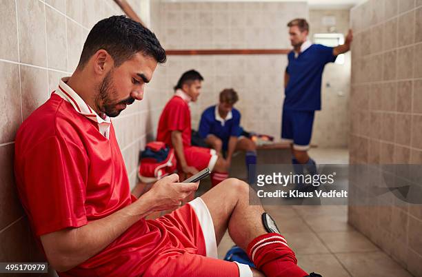 football teammates in changing room - football phone stock pictures, royalty-free photos & images