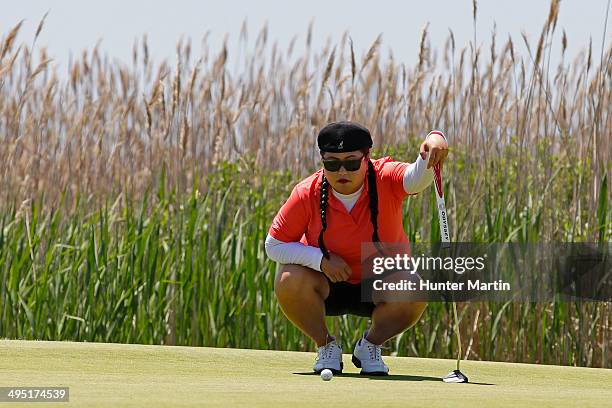 Christina Kim lines up her putt on the second hole during the final round of the ShopRite LPGA Classic presented by Acer on the Bay Course at the...
