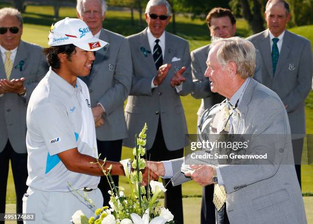 Hideki Matsuyama of Japan is presented the trophy by Jack Nicklaus after winning the Memorial Tournament presented by Nationwide Insurance at...