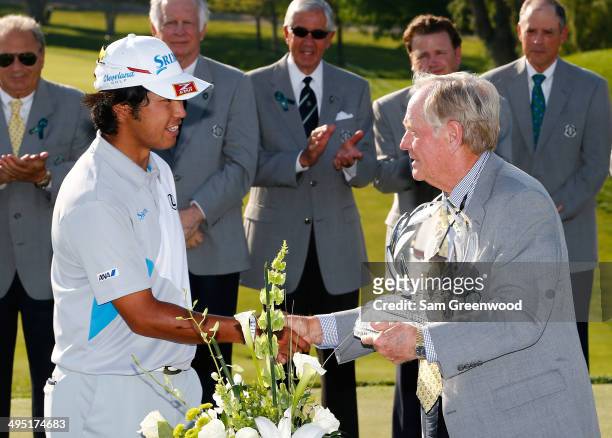 Hideki Matsuyama of Japan is presented the trophy by Jack Nicklaus after winning the Memorial Tournament presented by Nationwide Insurance at...