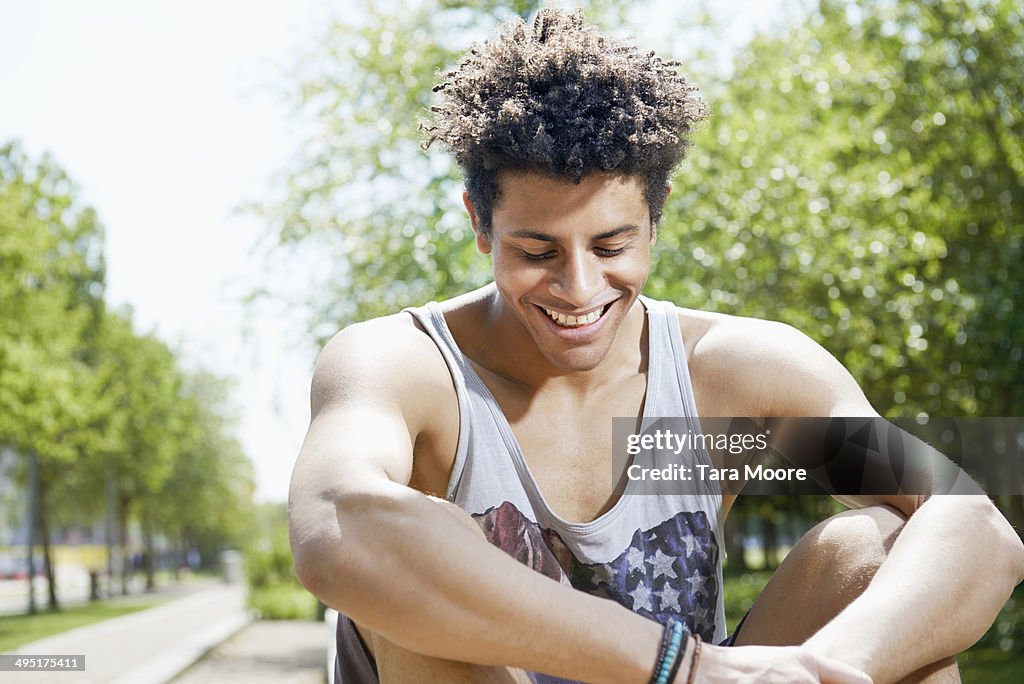 Young urban man laughing in park