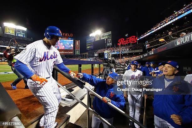 Michael Conforto of the New York Mets celebrates in the dugout after hitting a solo home run in the third inning against the Kansas City Royals...