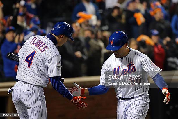 Michael Conforto of the New York Mets celebrateswith Wilmer Flores after hitting a solo home run in the third inning against the Kansas City Royals...