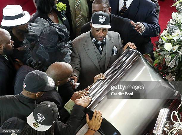 In this handout photo provided by the Palm Beach Post, family members close the casket during the funeral for Corey Jones at Payne Chapel AME at...