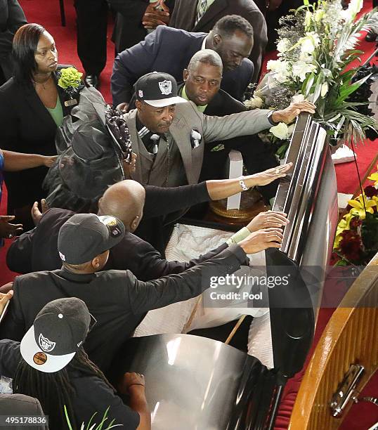 In this handout photo provided by the Palm Beach Post, family members prepare to close the casket during the funeral for Corey Jones at Payne Chapel...