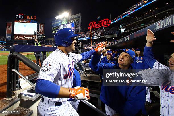 Michael Conforto of the New York Mets celebrates in the dugout after hitting a solo home run in the fifth inning against Danny Duffy of the Kansas...