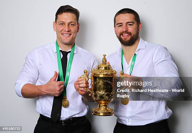 Tawera Kerr-Barlow and Dane Coles of the New Zealand All Blacks poses with the Webb Ellis Cup after the 2015 Rugby World Cup Final match between New...