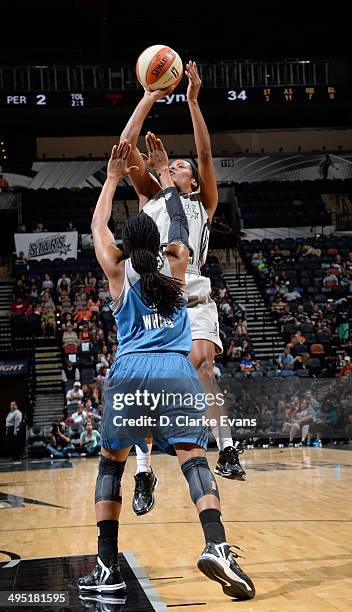 Jia Perkins of the San Antonio Stars shoots against Tan White of the Minnesota Lynx at the AT&T Center on June 1, 2014 in San Antonio, Texas. NOTE TO...