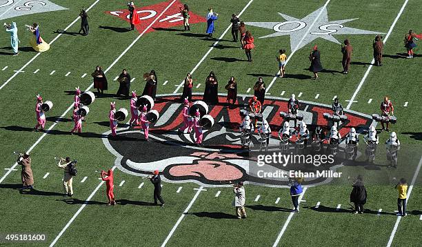Members of the UNLV Rebels marching band perform in costumes before the team's game against the Boise State Broncos at Sam Boyd Stadium on October...