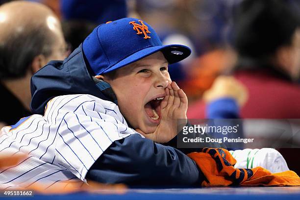 Young New York Mets fan cheers during Game Four of the 2015 World Series at Citi Field on October 31, 2015 in the Flushing neighborhood of the Queens...