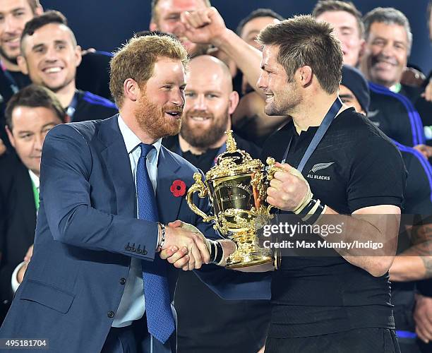 Prince Harry presents Richie McCaw with the Webb Ellis Cup after New Zealand beat Australia in the 2015 Rugby World Cup Final at Twickenham Stadium...