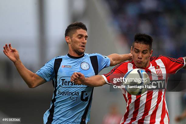 Esteban Espindola of Belgrano fights for the ball with Carlos Auzqui, of Estudiantes during a match between Belgrano and Estudiantes as part of 29th...