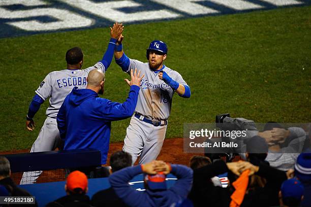 Ben Zobrist of the Kansas City Royals celebrates after scoring in the eighth inning with Alcides Escobar against the New York Mets during Game Four...