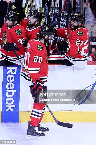 Brandon Saad of the Chicago Blackhawks celebrates with teammate Johnny Oduya after scoring a goal against Jonathan Quick of the Los Angeles Kings in...