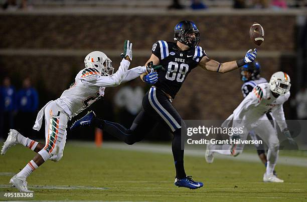 Corn Elder of the Miami Hurricanes defends a pass to Erich Schneider of the Duke Blue Devils during their game at Wallace Wade Stadium on October 31,...