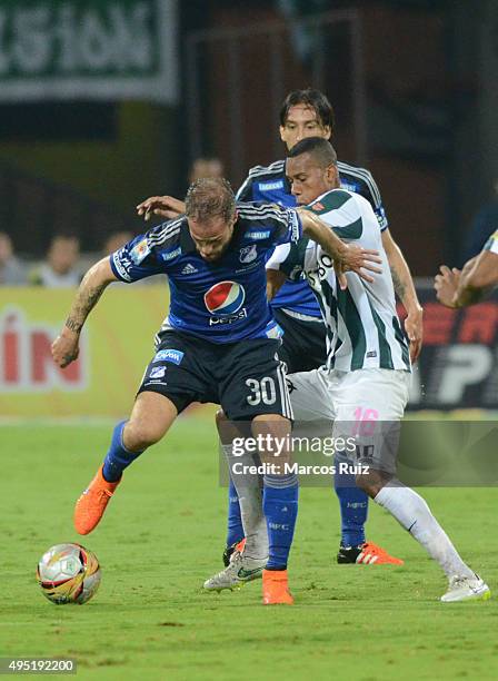 Federico Insua of Millonarios fights for the ball with Jonathan Copete of Nacional during a match between Atletico Nacional and Millonarios as part...