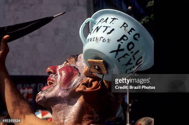Rio de Janeiro street carnival, portrait of man dressed up as clown with a chamber-pot attached to head, Brazil.