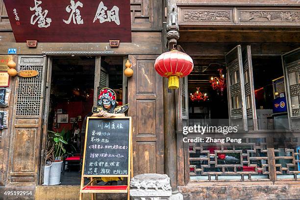 Man is dressed up as a face-changing performer outside a teahouse to attract tourists. Face-Changing opera is an ancient Chinese dramatic art that is...