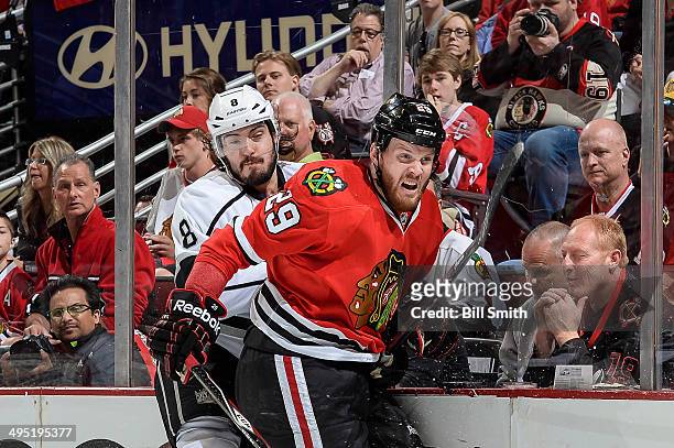 Bryan Bickell of the Chicago Blackhawks checks Drew Doughty of the Los Angeles Kings into the boards in Game Seven of the Western Conference Final...