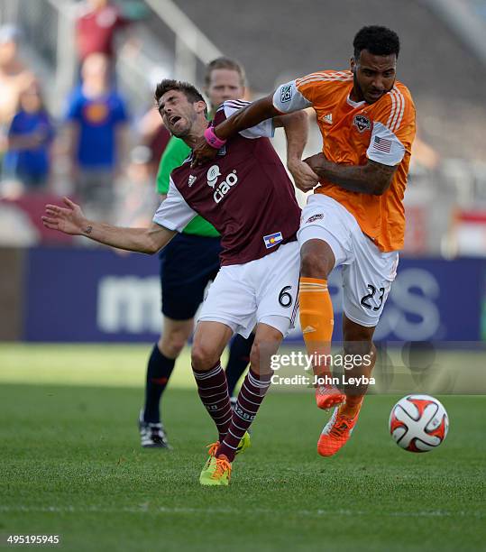 Houston Dynamo midfielder Giles Barnes gives a shove to Colorado Rapids midfielder Jose Mari as he goes after the ball during the first half June 1,...