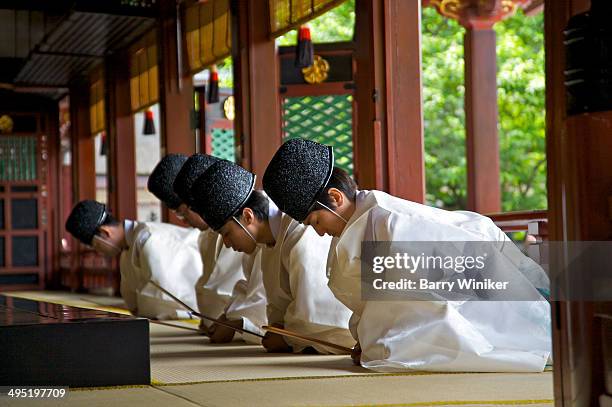 five priests praying inside shrine - dazaifu tenmangu shrine stock pictures, royalty-free photos & images