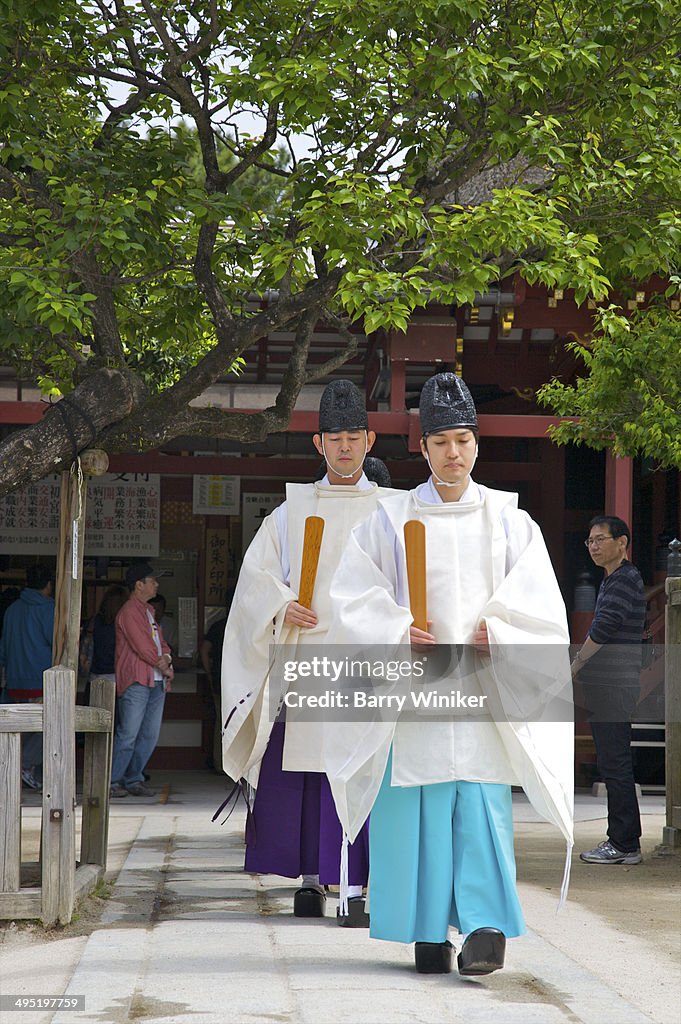 Priests in a row leaving shrine