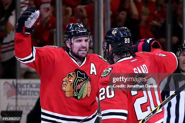Patrick Sharp of the Chicago Blackhawks celebrates with teammate Brandon Saad after scoring a goal against Jonathan Quick of the Los Angeles Kings in...