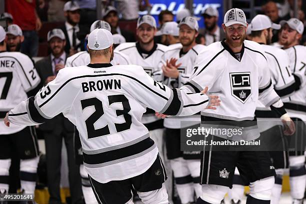 Dustin Brown and Jeff Carter of the Los Angeles Kings celebrate defeating the Chicago Blackhawks 5 to 4 in overtime in Game Seven to win the Western...