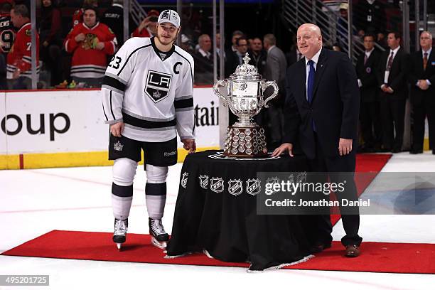 Dustin Brown of the Los Angeles Kings and Deputy commissioner Bill Daly pose with The Clarence S. Campbell Bowl after defeating the Chicago...