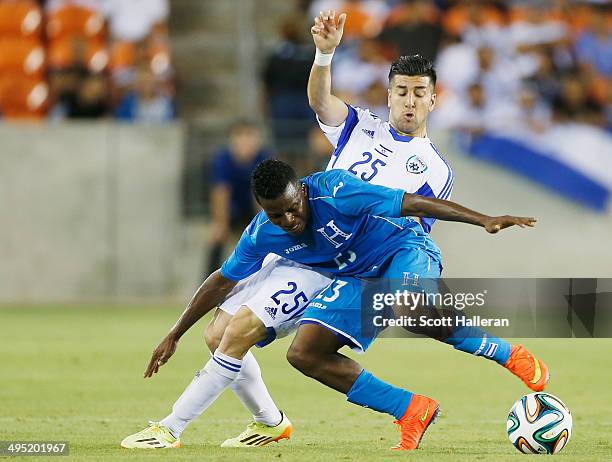Marvin Chavez of Honduras battles for the ball with Avraham Rikan of Isreal during their Road to Brazil match at BBVA Compass Stadium on June 1, 2014...