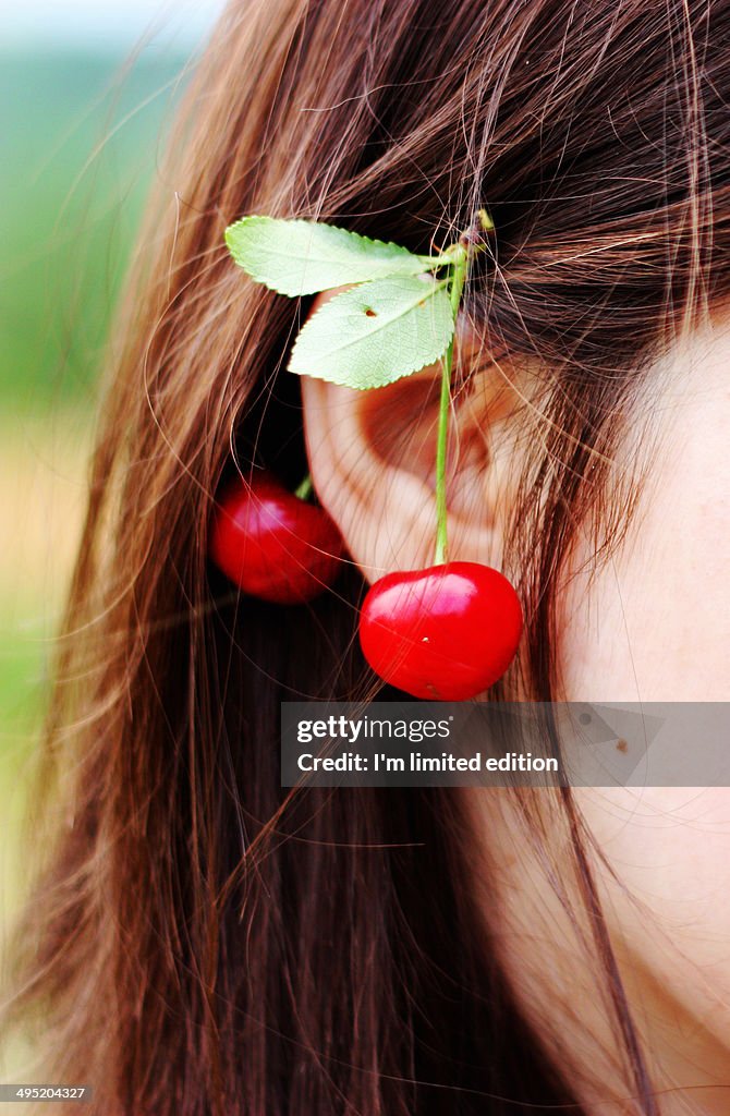 Woman with cherries on her ear