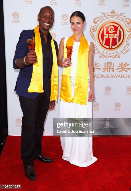 Actors Tyrese Gibson and Jordana Brewster pose with the Best Global Movie of the Year award for "Fast & Furious 6" in the press room during the...