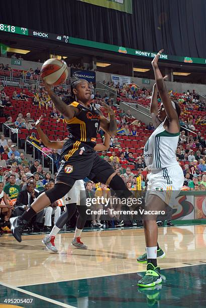 Riquna Williams of the Tulsa Shock looks to pass against Camille Little of the Seattle Storm during the game on June 1,2014 at Key Arena in Seattle,...